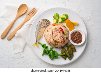 Thai Shrimp Paste Fried Rice With fried mackerel, served with fried Acacia egg and boiled Vegetable.Top view