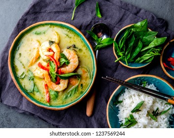 THAI SHRIMPS GREEN CURRY. Thailand tradition green curry soup with shrimps prawns and coconut milk. Green Curry in blue plate on gray background