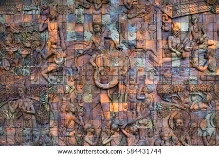 Thai stone carving art, Buddhist bas relief sculpture with vary detailed human figures pattern, Buddhist mural art, Thailand stone art. Bright colorful background photo.