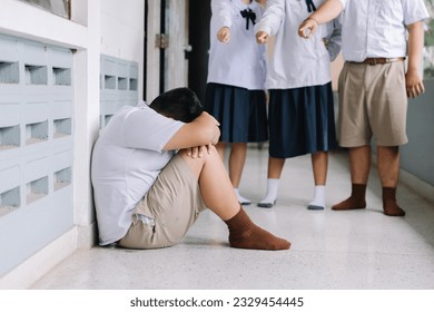 Thai student bullying victim by classmates crying sadly being bullied, concept of being bullied by schoolmates causing stress and physical and psychological harm.
 - Powered by Shutterstock