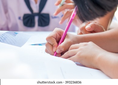 Thai Students Writing On A Paper For Admissions In High School, Thailand