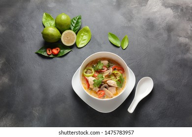 Thai style coconut milk soup-Tom Kha Gai with chicken,mushrooms, galangal, lime leaves, lemongrass, chili peppers. Thai cuisine food concept - Shutterstock ID 1475783957