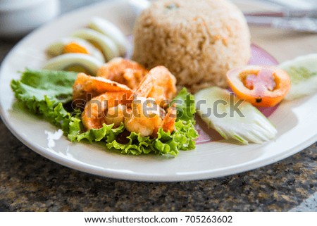 Thai style cuisine fried rice with shrimp and egg,Woman eating boiled shrimp with fry rice and boil egg, Concept of healhty food or cuisine
