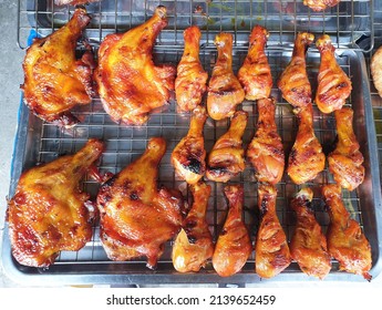 Thai style grilled chicken on stainless steel tray, selling at a shop, street food in Thailand.