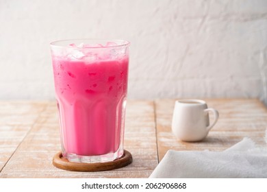 Thai style iced pink milk.Cold sweet drink Red Grenadien Sugar Syrup mix with milk and iced cube in glass