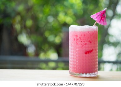 Thai style iced pink sweet milk is a milk drink mix with sweet red water drink in glass