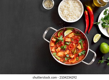 Thai style red chicken curry in pan over black stone background with free text space. Top view, flat lay - Shutterstock ID 2104234292