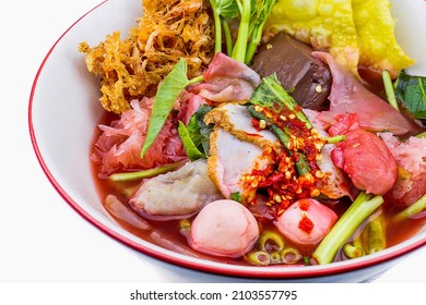 Thai style spicy instant noodles soup in bowl, Yentafo Tom Yum with Thai herbs, Thai food, Noodle soup on white background. - Shutterstock ID 2103557795