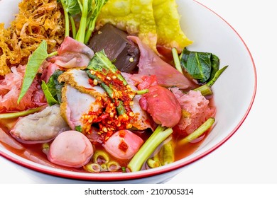 Thai style spicy instant noodles soup in bowl, Yentafo Tom Yum with Thai herbs, Thai food, Noodle soup on white background. - Shutterstock ID 2107005314