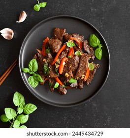 Thai style stir-fry beef with vegetables over black stone background. Top view, flat lay - Powered by Shutterstock