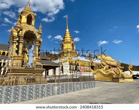 Thai temple in the upper northern region of Thailand. Located in Chiang Rai. Golden Temple, Chedi. Beautiful golden color in Lanna style.