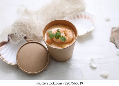 Thai Tom Kha Soup With King Prawns. Oriental Shrimp Soup In A Take-away Carton Box, On A White Background, Top View, Selective Focus.