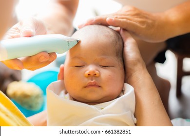 In Thai tradition, the hair from birth is associated with undesirable traits from past lives. the child is freshly shave to signify freedom from the past and moving into future.baby is two months old