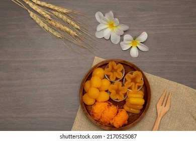 Thai traditional dessert concept, Thong yip thong yod foi thong and jackfruit seeds in wood bowl.