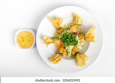 Thai Traditional Fried Spring Rolls ( Money Bag ) With Sweet Plum Sauce In A Paper Top View On White Backgruond