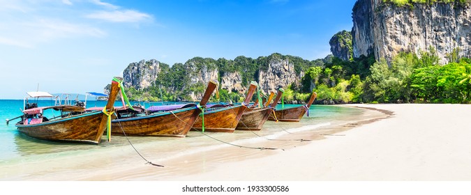 Thai traditional wooden longtail boat and beautiful sand Railay Beach in Krabi province. Ao Nang, Thailand. - Powered by Shutterstock