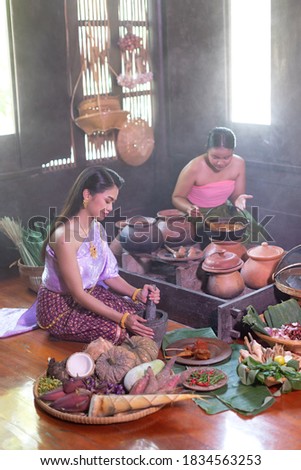 Thai woman cooking in retro Thai dress