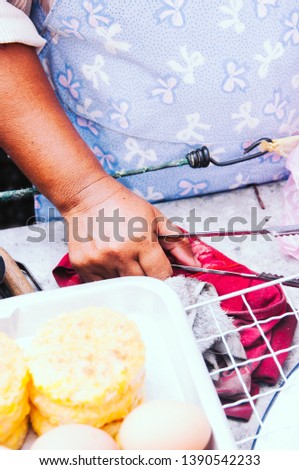 : Thai woman cooks and sells potatoes pancakes 