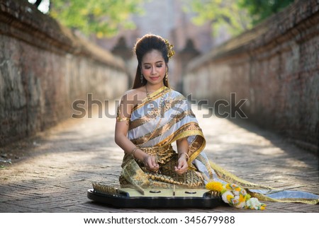 Thai woman playing dulcimer  