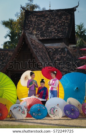 Thai Woman In Traditional Costume (Lanna culture style) with Thailand beautiful  painting umbrella,chiangmai Thailand.