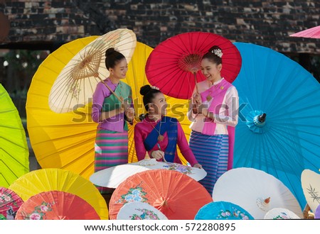 Thai Woman In Traditional Costume (Lanna culture style) with Thailand beautiful  painting umbrella,chiangmai Thailand.