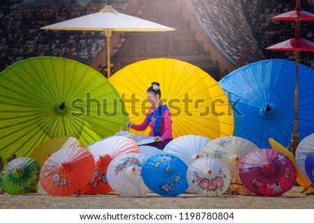 Thai Woman In Traditional Costume of northThailand painting umbrella vintage style,chiangmai Thailand