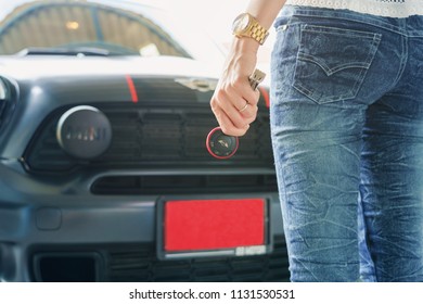 Thailand :26 June 2016, Woman Holding Remote Control Car Key In Front Of Mini Cooper With Red Registration Plate.ready To Travel.