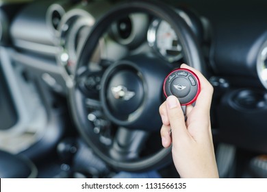 Thailand :26 June 2016, Woman Holding Remote Control Key In Mini Cooper Car.