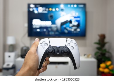 Thailand - April 2021 : A Gamer Is Playing Play Station 5 At Home, His Hand Holding 