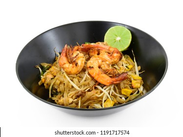 Thailand or asia food Fried rice Noodles and shrimp "Pad Thai"with and vegetables in black dish isolated on white background.