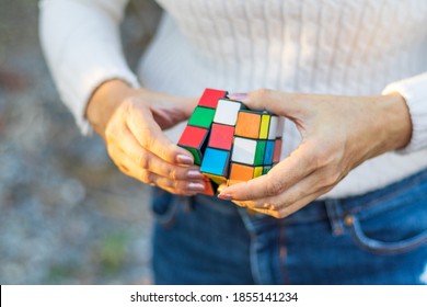Thailand, bangkok. November 16, 2020.Hand holding rubik's cube on green natural blur background. - Shutterstock ID 1855141234