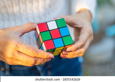 Thailand, bangkok. November 16, 2020.Hand holding rubik's cube on green natural blur background. - Shutterstock ID 1855142626