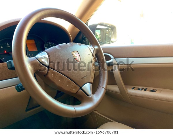 Thailand, Bangkok\
November 30, 2019 : Beautiful brown Steering wheel with many button\
function, horn and Air Bag. Cayenne model. 4 wheel car. Exclusive.\
Super car. Copy\
space.