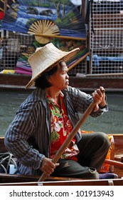 Thailand, Bangkok, a Thai woman on her boat at the Floating Market