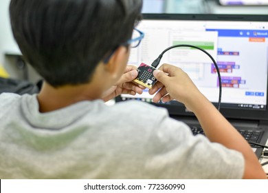 Thailand, December, 2017. The Young Asian Boy Is Coding Program To Micro Bit For Creating The My Pets Project In The Coding For Kids Classroom In Thailand.