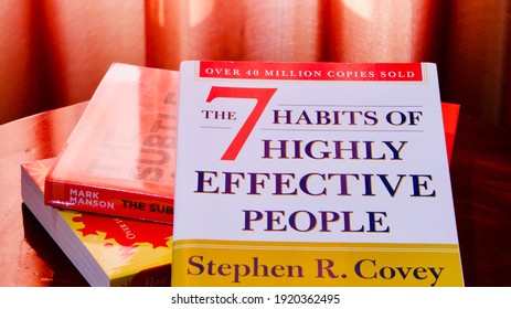 Thailand - Feb 19 2021: For Illustrative Editorial Use Only, The Very Famous Book 7 Habits Of Highly Effective People By Stephen R. Covey On Other Books, Under Natural Light Through Red Curtain.