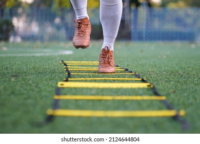 Thailand - Feb 2022 : A Football Player, Who Wearied Vintage Style Brown Color Football Shoe, Is Training Speed Agility On Artificial Turf By Using Step Ladder Equipment. Close-up And Selective Focus.