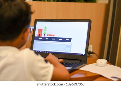 Thailand, February 2018. Phil The Young Asian Boy Is Coding His Program MSWLogo Language To Build The Pictures In The Coding For Kids Classroom In Bangkok Thailand.