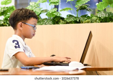 Thailand, February 2018. Phil The Young Asian Boy Is Coding His Program MSWLogo Language To Build The Pictures In The Coding For Kids Classroom In Bangkok Thailand.