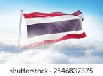 Thailand flag wavering in beautiful clouds with building skyline. The flag with drone shot in beautiful sky. Thailand national flag for independence day.