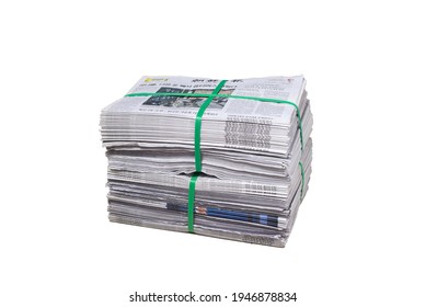 Thailand - Mar 30, 2021: Bundle Of Korean Newspapers Isolated On White Background. Pile Old Advertising Newspaper, Tied With Green Plastic Rope, Suitable For Reuse. Stack Of Recycle Paper For Sale