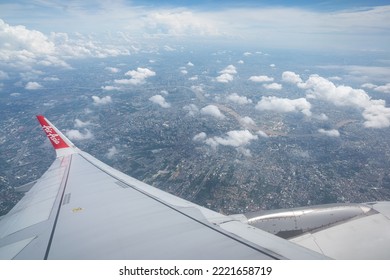 Thailand - October 2022 : An Air Asia Commercial Passenger Flight Is Flying In Little Cloudy Sky And Clearly Atmosphere. Transportation Industrial Editorial Photo.