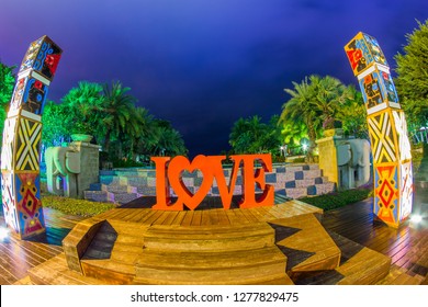 Thailand , Pattaya - January 1, 2019. Celebration of St. Valentine's Day on the tropical islands. luxury vacation. Inscription love and night lights on the background of exotic palms and night sky