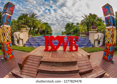 Thailand , Pattaya - January 1, 2019. Celebration of St. Valentine's Day on the tropical islands. luxury vacation. Inscription love and night lights on the background of exotic palms and night sky