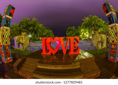 Thailand , Pattaya - January 1, 2019. Celebration of St. Valentine's Day on the tropical islands. luxury vacation. Inscription love and night lights on the background of exotic palms and night sky