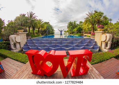 Thailand , Pattaya - January 1, 2019. Celebration of St. Valentine's Day on the tropical islands. luxury vacation. Inscription love and night lights on the background of exotic palms and night sky
