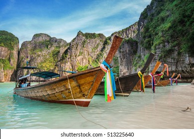Thailand sea beach view round with steep limestone hills with many traditional longtail boats parking at Maya Bay, Ko Phi Phi Leh island, part of Krabi, Andaman Sea
