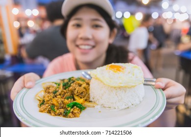 Thailand Street Food Delicious Tasty Of Jasmine Rice Top With Pork Chop Stir-fried With Basil Leaf And Fried Egg Most Popular Food Present To Tourist By Thai Cute Women