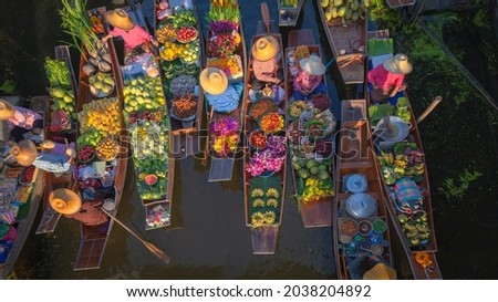 Thailand traditional ancient floating market peoples sell agriculture fruit, food on wooden boat is popular tourist attraction canals of Thailand.