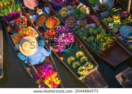 Thailand traditional ancient floating market peoples sell agriculture fruit, food on wooden boat is popular tourist attraction canals of Thailand. Concept Aerial view.